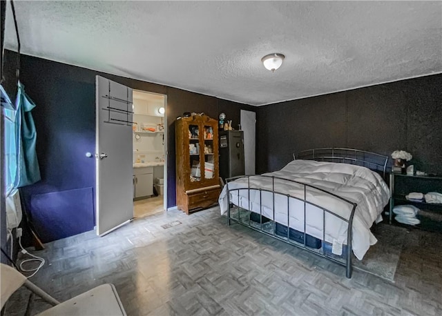 bedroom featuring a textured ceiling and light parquet floors