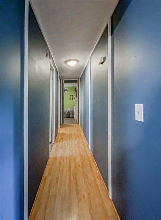 hallway with light hardwood / wood-style floors