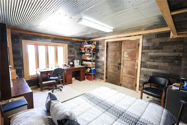 carpeted office space featuring wooden walls