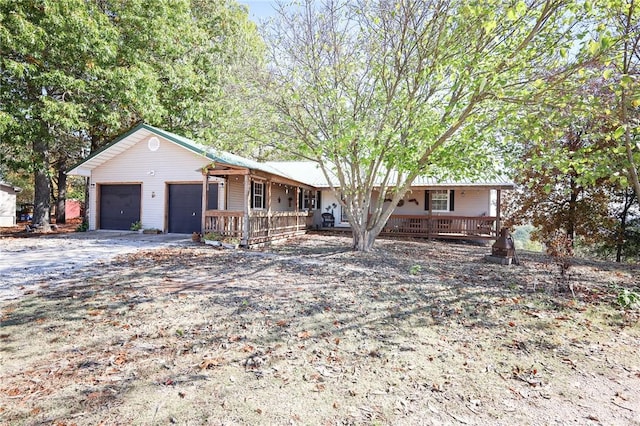 single story home featuring a garage and covered porch