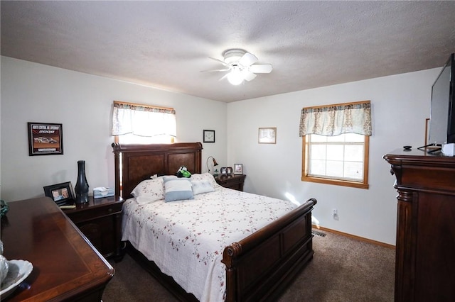 bedroom featuring dark colored carpet and ceiling fan