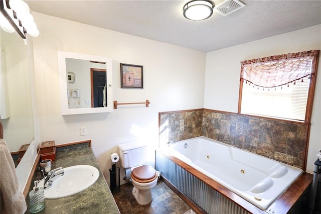 bathroom featuring vanity, a bath, and toilet