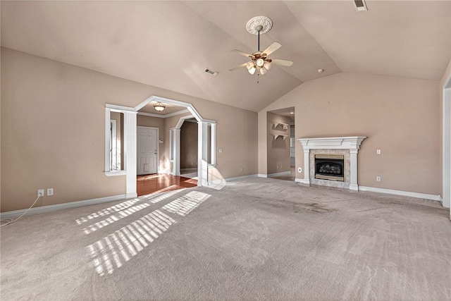 unfurnished living room featuring ceiling fan, light colored carpet, lofted ceiling, and a fireplace