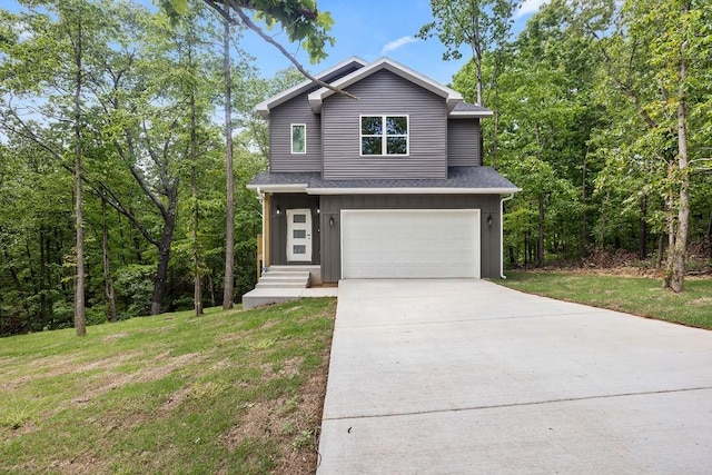 view of front of property featuring a front lawn and a garage