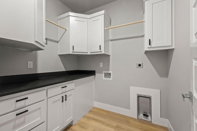 washroom featuring cabinets, hookup for a washing machine, light hardwood / wood-style flooring, and hookup for an electric dryer