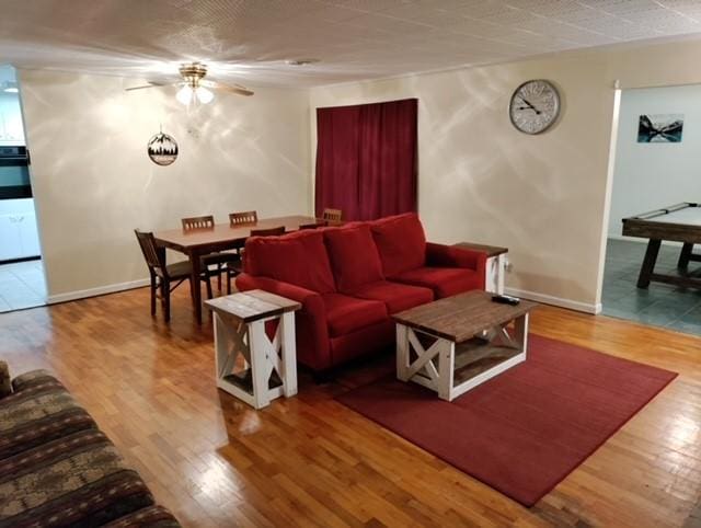 living room with hardwood / wood-style floors and ceiling fan