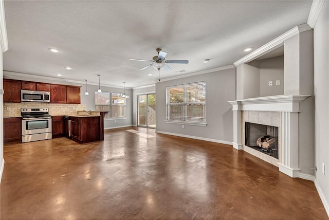 unfurnished living room with a tile fireplace, ceiling fan, a textured ceiling, and ornamental molding