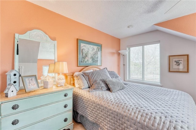 bedroom featuring lofted ceiling and a textured ceiling