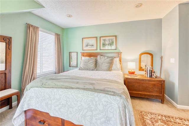 carpeted bedroom featuring a textured ceiling and lofted ceiling