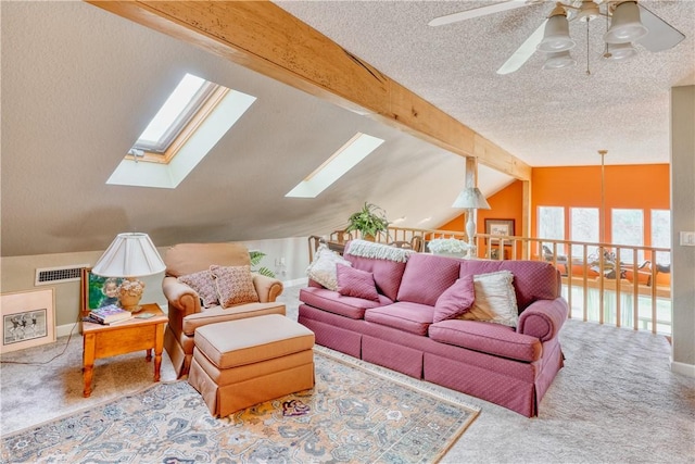 living room with vaulted ceiling with beams, ceiling fan, carpet floors, and a textured ceiling