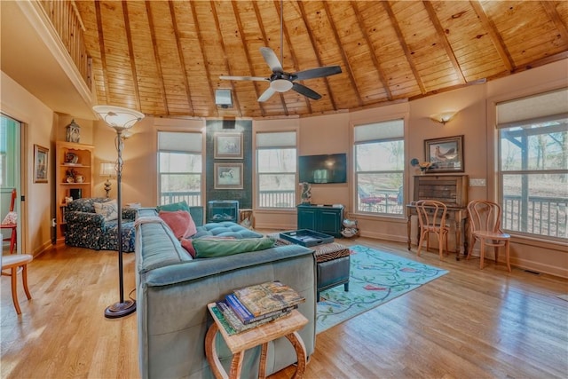 living room with ceiling fan, beamed ceiling, wooden ceiling, and light wood-type flooring