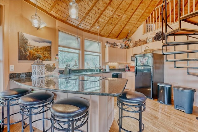 kitchen featuring high vaulted ceiling, kitchen peninsula, black appliances, a breakfast bar, and wood ceiling