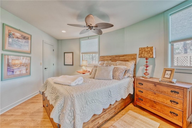 bedroom with light hardwood / wood-style flooring and ceiling fan