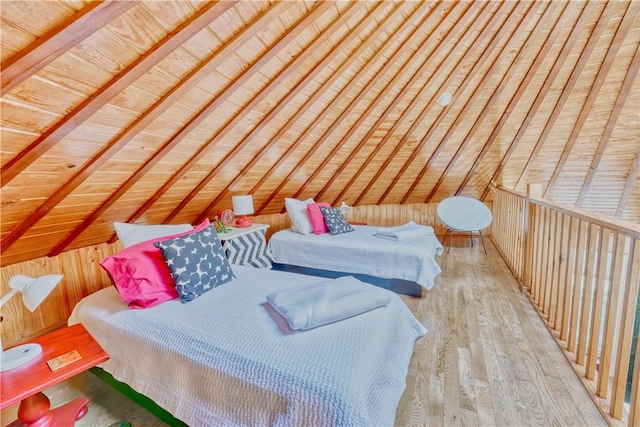 bedroom featuring vaulted ceiling with beams, wooden ceiling, wooden walls, and light hardwood / wood-style flooring