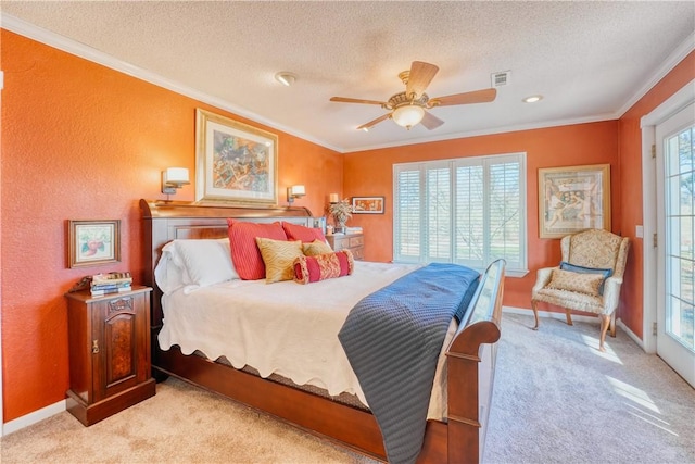 carpeted bedroom featuring multiple windows, a textured ceiling, ceiling fan, and ornamental molding