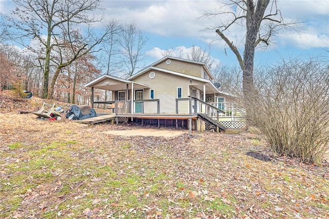 back of house with a deck