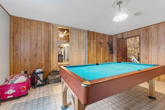 rec room featuring a textured ceiling, pool table, wood walls, and tile patterned floors