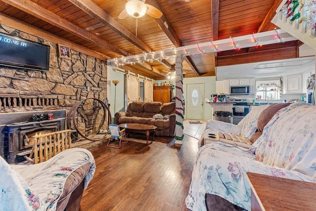 living room featuring hardwood / wood-style flooring, ceiling fan, wood ceiling, and beamed ceiling