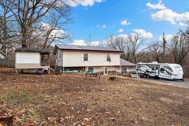 back of property featuring a storage shed