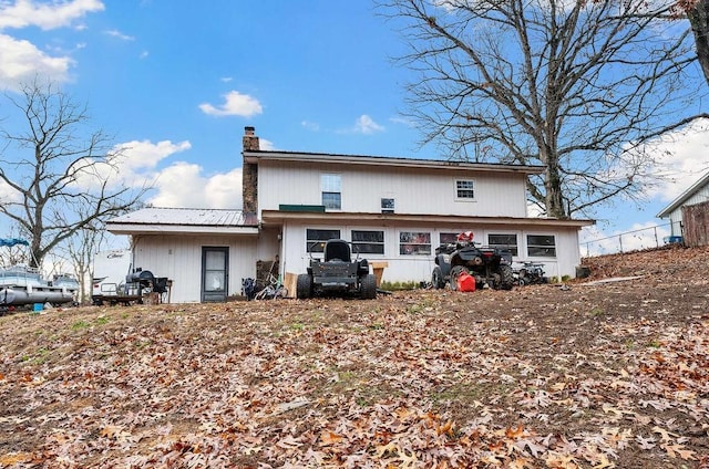 rear view of property with a chimney