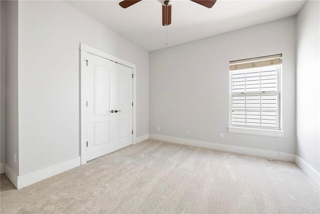 3706 Cherokee Rd, Rogers, AR 72758 - unfurnished bedroom with a closet, carpet, a ceiling fan, and baseboards