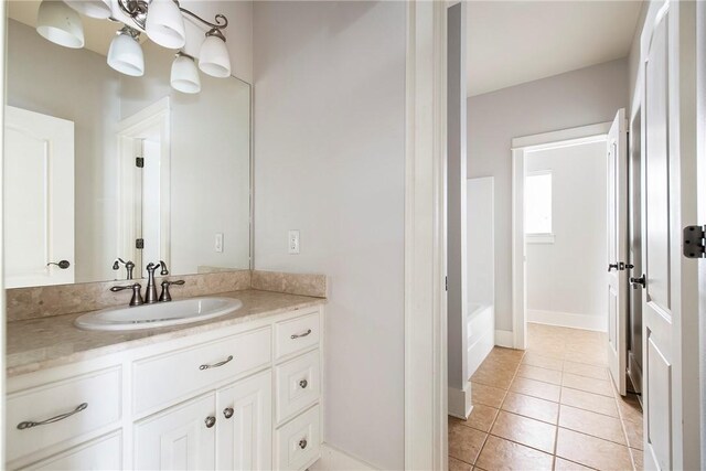 3706 Cherokee Rd, Rogers, AR 72758 - bathroom with a tub to relax in, vanity, baseboards, and tile patterned floors