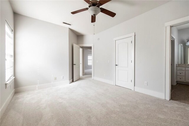 3706 Cherokee Rd, Rogers, AR 72758 - unfurnished bedroom featuring visible vents, baseboards, ensuite bath, ceiling fan, and carpet