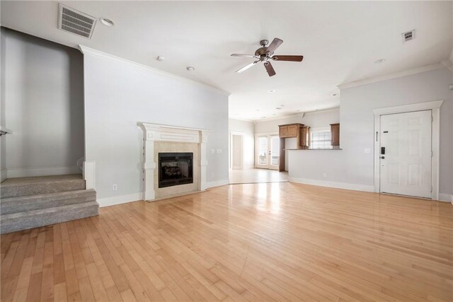 3706 Cherokee Rd, Rogers, AR 72758 - unfurnished living room featuring ornamental molding, light wood-style flooring, a premium fireplace, and visible vents