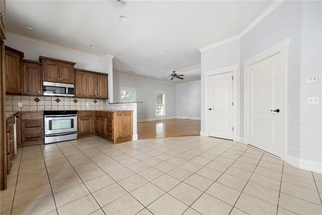 3706 Cherokee Rd, Rogers, AR 72758 - kitchen with crown molding, light tile patterned floors, stainless steel appliances, decorative backsplash, and a peninsula