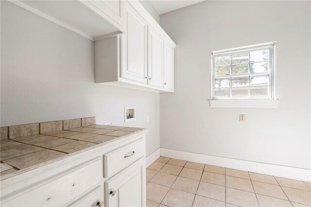 3706 Cherokee Rd, Rogers, AR 72758 - clothes washing area featuring light tile patterned floors, hookup for a washing machine, cabinet space, and baseboards