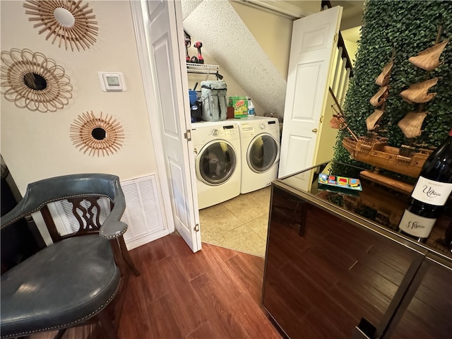 laundry room with dark hardwood / wood-style flooring and independent washer and dryer