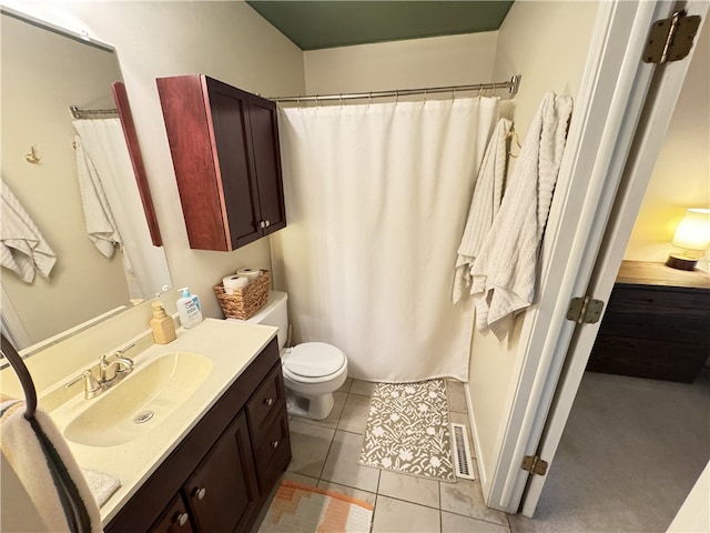 bathroom with tile patterned flooring, vanity, and toilet