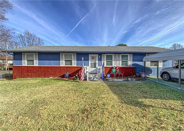 single story home with a front yard and a carport