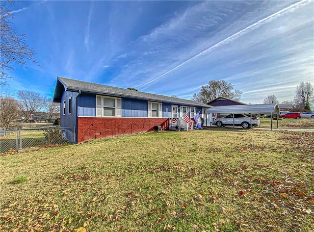 ranch-style house with a front yard and a carport