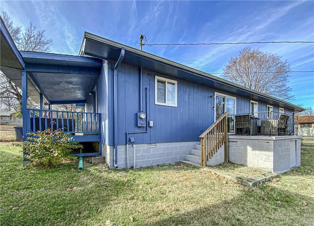 rear view of property with a lawn