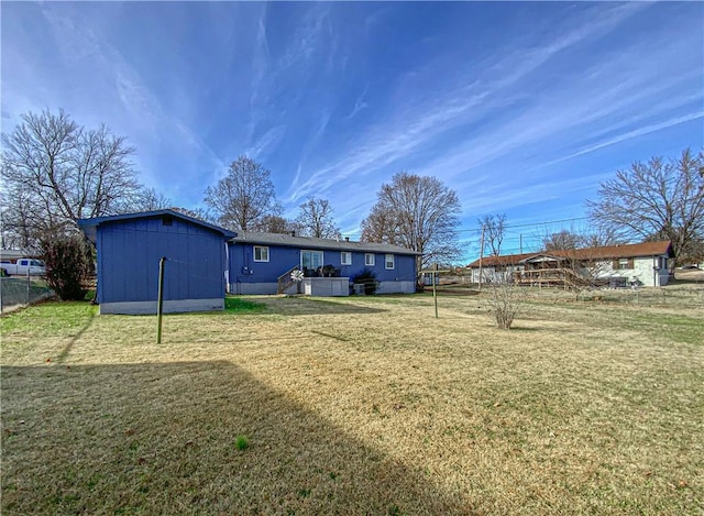 back of house featuring a lawn