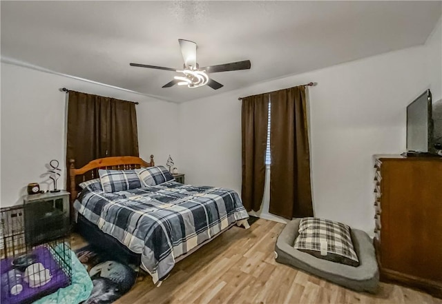 bedroom featuring ceiling fan and light hardwood / wood-style flooring