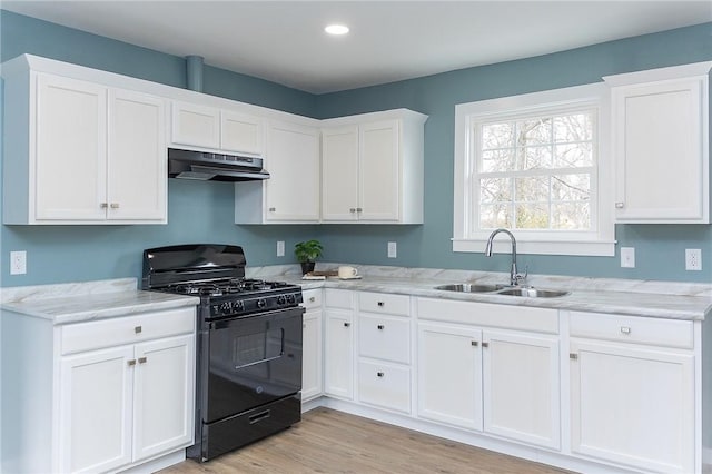 kitchen featuring light hardwood / wood-style floors, black gas stove, sink, and white cabinets