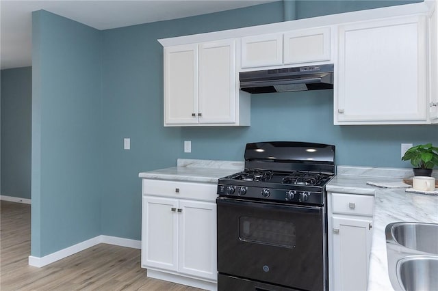 kitchen featuring black gas range, sink, light hardwood / wood-style flooring, and white cabinets