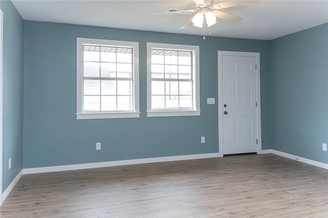 unfurnished room with hardwood / wood-style flooring and ceiling fan