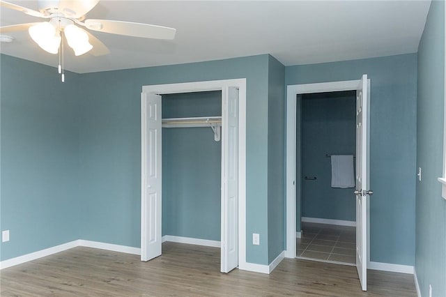 unfurnished bedroom featuring wood-type flooring, ceiling fan, and a closet