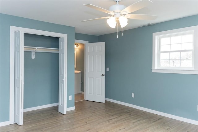 unfurnished bedroom featuring ceiling fan, a closet, and light hardwood / wood-style flooring