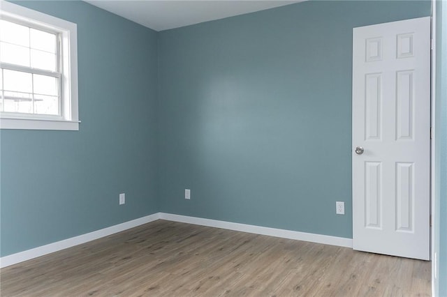 unfurnished room with light wood-type flooring