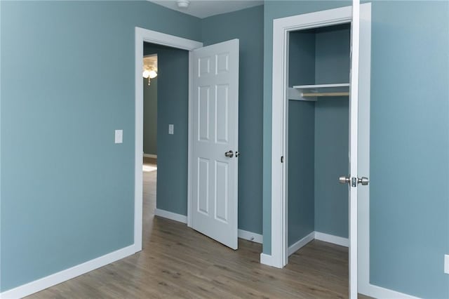 unfurnished bedroom featuring light hardwood / wood-style floors and a closet