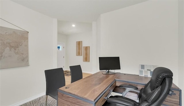 home office with light hardwood / wood-style floors