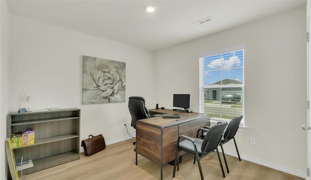 office space with light wood-type flooring