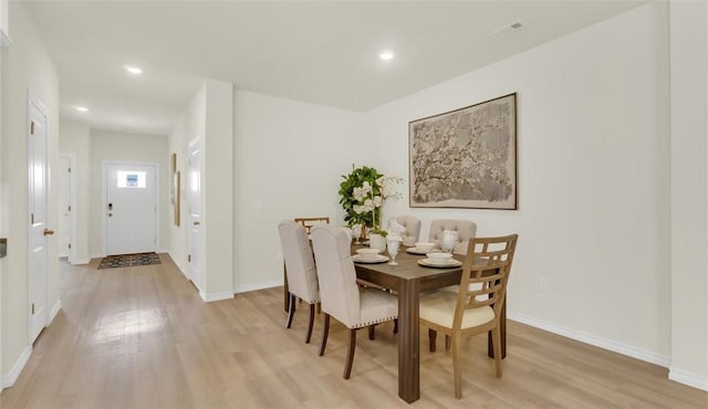 dining space with light hardwood / wood-style floors