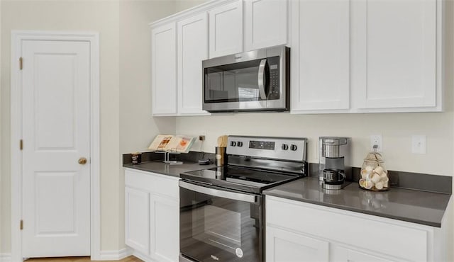 kitchen with white cabinetry and appliances with stainless steel finishes