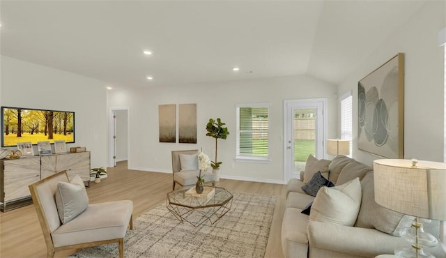 living room with lofted ceiling and light wood-type flooring