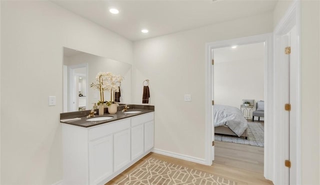 bathroom with vanity and wood-type flooring